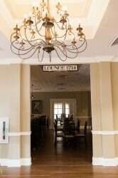 Hallway entrance with chandelier, sign 